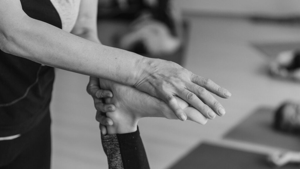 Physiotherapist assisting a patient with hand therapy